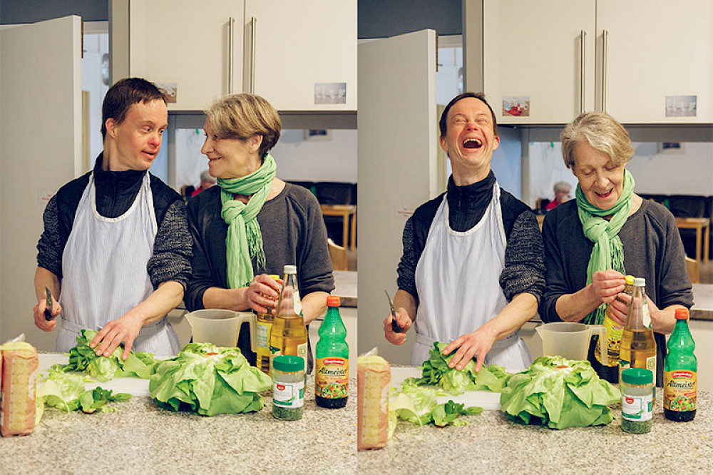 Image shows two people in the kitchen.